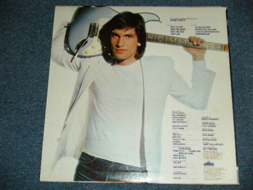 Roger Voudouris - On The Heels Of Love (Vinyl, LP, Album) Near Mint (NM or M-) / Good Plus (G+)