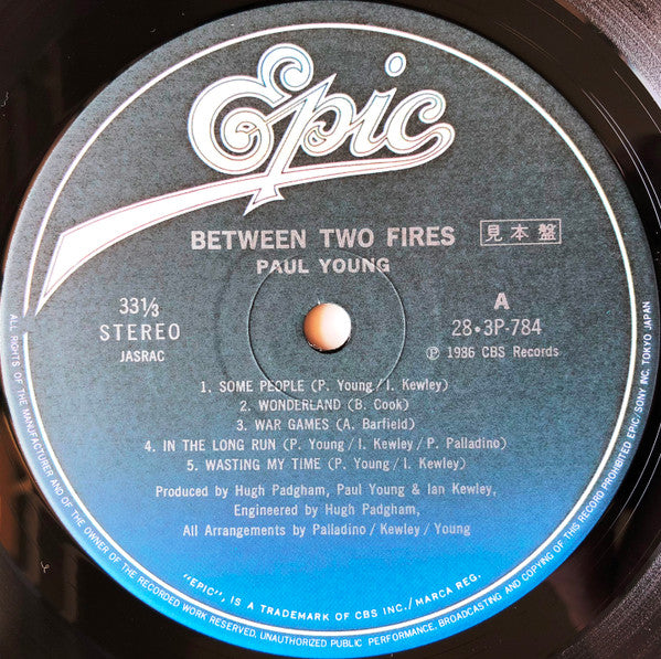 Paul Young - Between Two Fires (Vinyl, LP, Album, Promo) Very Good Plus (VG+) / Very Good Plus (VG+)